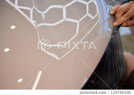 Applying a Protective Film on the Surface of Your Car for Enhanced Durability and Shine 128788100