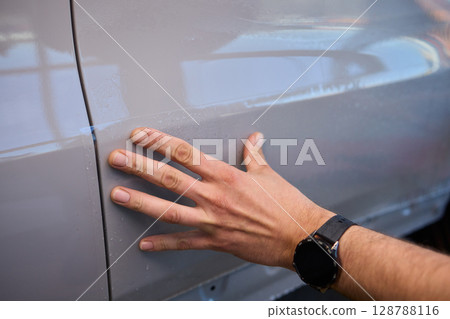 Applying a Protective Film on the Surface of Your Car for Enhanced Durability and Shine 128788116