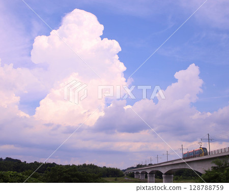 Utsunomiya City: LRT (next-generation streetcar) crossing the Kinugawa River and cumulonimbus clouds 128788759