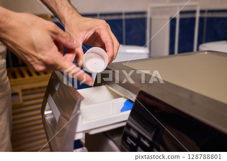 To achieve cleaner clothes, adding the right type of detergent to your washing machine is essential To achieve cleaner clothes, adding the right type of detergent to your washing machine is essential 128788801