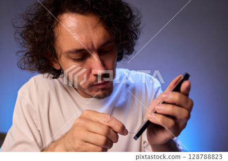 The Innovative Smartphone Cleaning Device is Being Demonstrated During Use and Functionality The Innovative Smartphone Cleaning Device is Being Demonstrated During Use and Functionality 128788823