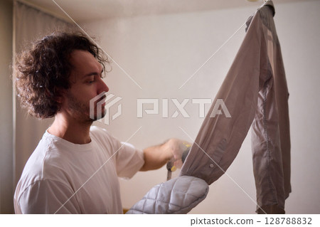 Using a Steam Iron expertly irons a shirt for a flawless, wrinkle free, polished look Using a Steam Iron expertly irons a shirt for a flawless, wrinkle free, polished look 128788832