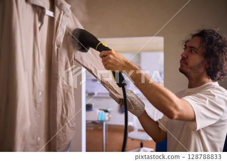 Using a Steam Iron expertly irons a shirt for a flawless, wrinkle free, polished look 128788833