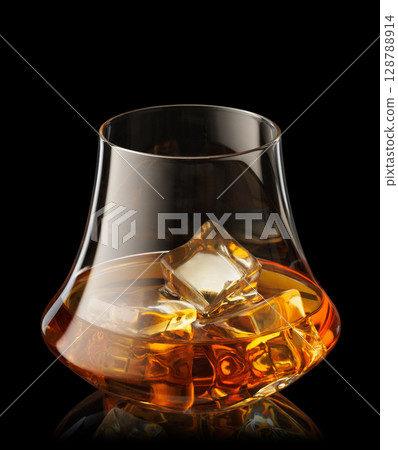 Glass of scotch whiskey or bourbon with ice isolated on black background Glass of scotch whiskey or bourbon with ice isolated on black background 128788914