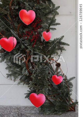 Red hearts on fir branches. Red hearts on fir branches. 128789645