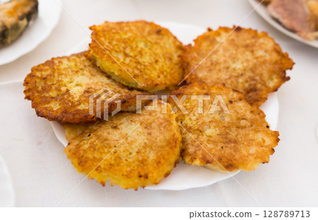 Potato pancakes with sour cream on white plate 128789713