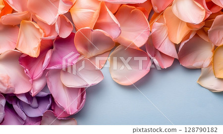 Colorful Rose Petals in Soft Shades of Pink and Purple on Light Blue Background 128790182