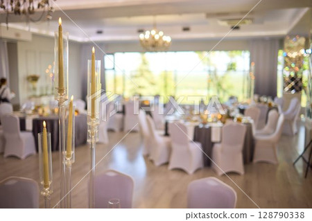 An Elegant Event Venue featuring Candlelit Centerpieces and Exquisitely Refined An Elegant Event Venue featuring Candlelit Centerpieces and Exquisitely Refined 128790338