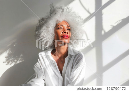 Embracing elegance and natural beauty of black middle aged woman 128790472