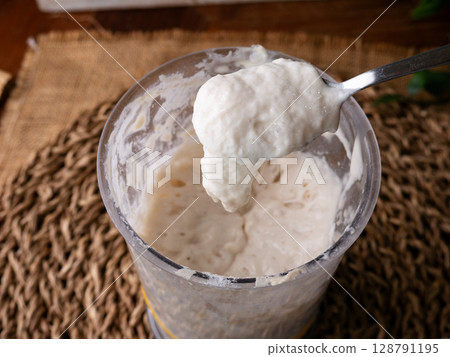 Bubbly sourdough starter in glass jar. Active yeast for bread making 128791195