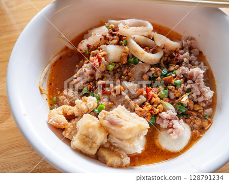 Tom Yum Seafood Noodles with Crispy Pork Cracklings or Pork Rinds. 128791234