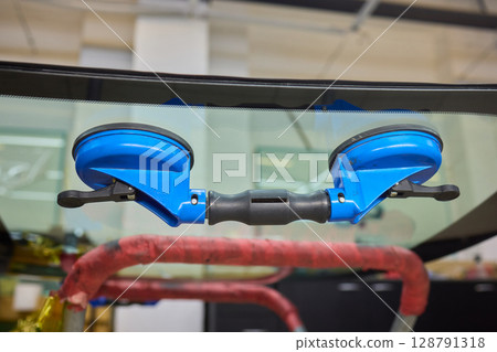 Installing windshield on a car with automotive design 128791318