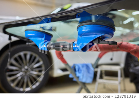 Installing windshield on a car with automotive design 128791319