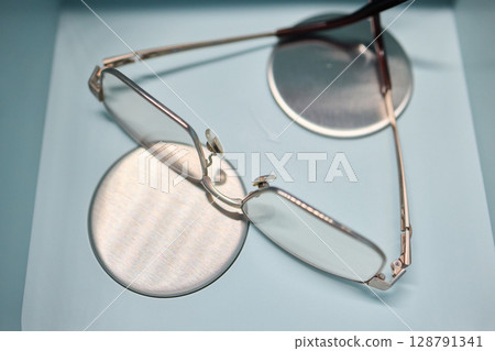 Eyewear care with our eyeglasses immersed in a state-of-the-art ultrasonic vibration cleaner. High-frequency vibrations to meticulously remove dirt and grime, ensuring your lenses are spotless. Eyewear care with our eyeglasses immersed in a state-of-the-art ultrasonic vibration cleaner. High-frequency vibrations to meticulously remove dirt and grime, ensuring your lenses are spotless. 128791341