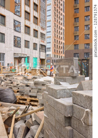 There are numerous piles of concrete debris observable at the busy construction site right now There are numerous piles of concrete debris observable at the busy construction site right now 128791374