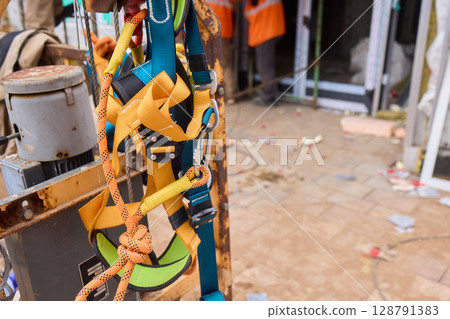 A vibrant and colorful equipment harness seen at a busy construction site, showcasing safety 128791383