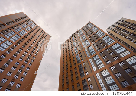 A bustling Construction Site showcasing Cranes, Building Framework, and full activity all around 128791444