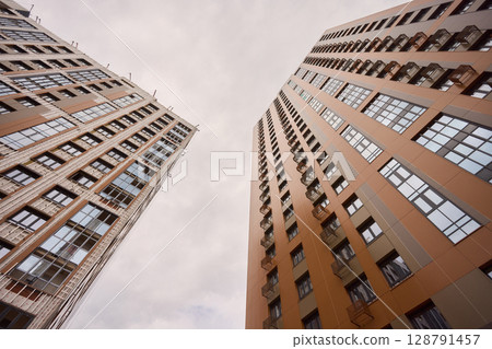 A bustling Construction Site showcasing Cranes, Building Framework, and full activity all around A bustling Construction Site showcasing Cranes, Building Framework, and full activity all around 128791457