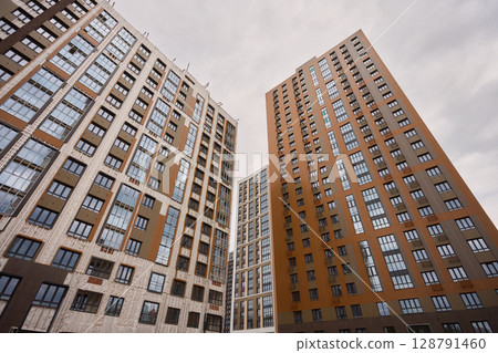 A bustling Construction Site showcasing Cranes, Building Framework, and full activity all around 128791460