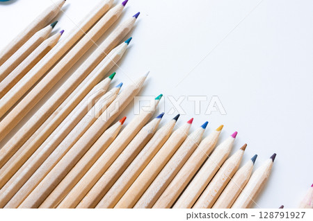 Colorful wooden pencils arranged on white background Colorful wooden pencils arranged on white background 128791927