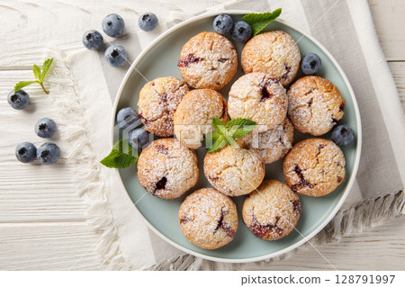 Gluten free blueberry cookies served with fresh blueberries closeup in the bowl. Horizontal top view Gluten free blueberry cookies served with fresh blueberries closeup in the bowl. Horizontal top view 128791997
