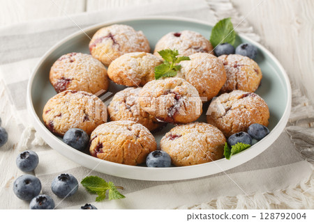 Berry chewy cookies with blueberries sprinkled with powdered sugar close-up in a plate. horizontal 128792004