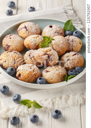 Cookies with blueberry filling sprinkled with powdered sugar closeup in the bowl. Vertical Cookies with blueberry filling sprinkled with powdered sugar closeup in the bowl. Vertical 128792007