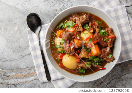 Semur Daging or Sweet Beef Stew closeup in the bowl. Horizontal top view Semur Daging or Sweet Beef Stew closeup in the bowl. Horizontal top view 128792008