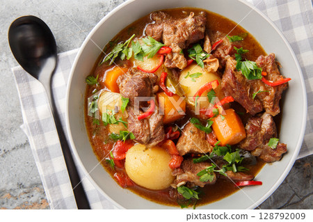 Semur Daging Indonesian braised beef with spices and sweet soy sauce closeup in the bowl. Horizontal top view 128792009