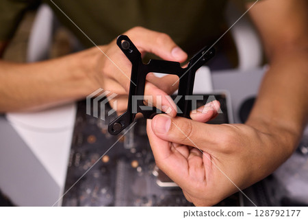 Hands Skillfully Assembling a Black Component for an Exciting Technology Project Hands Skillfully Assembling a Black Component for an Exciting Technology Project 128792177