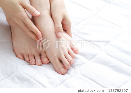 Woman's feet and ankles Woman's feet and ankles 128792397