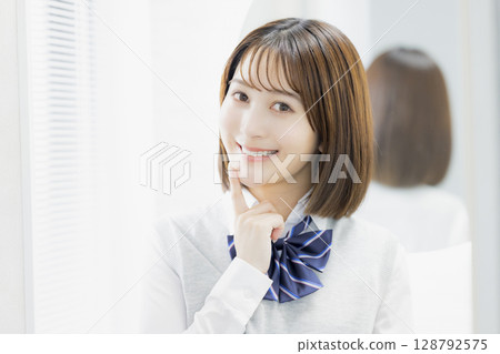 High school girl looking at a mirror 128792575
