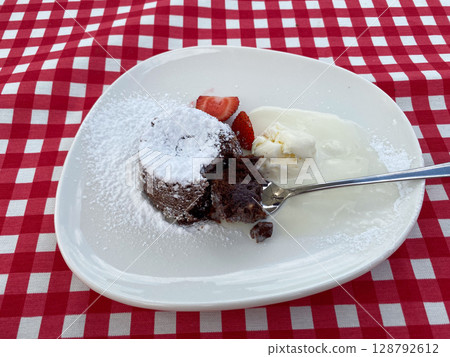 French dessert chocolate fondant with strawberries and ice cream. 128792612