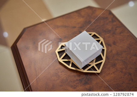 An Elegant White Box displayed on a beautifully Decorative Tray, perfect for any occasion An Elegant White Box displayed on a beautifully Decorative Tray, perfect for any occasion 128792874