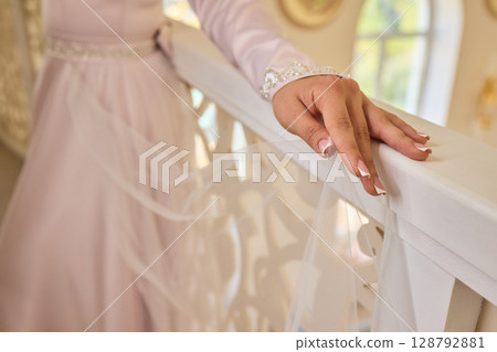 An Elegant Hand Resting on a White Bannister Adorned with Beautiful Delicate Fabric An Elegant Hand Resting on a White Bannister Adorned with Beautiful Delicate Fabric 128792881
