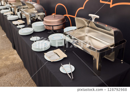 An Elegant Dining Setup Featuring a Silver Cloche and a Unique, Sophisticated Ambiance 128792988
