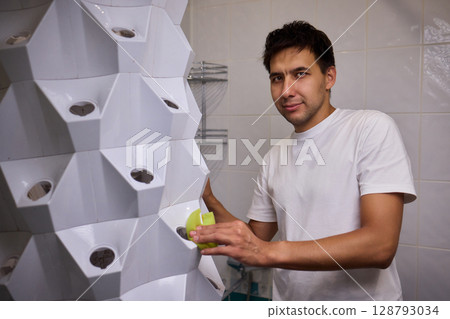 Engaging in a Cleaning Activity within a Contemporary Bathroom Environment Setting Engaging in a Cleaning Activity within a Contemporary Bathroom Environment Setting 128793034