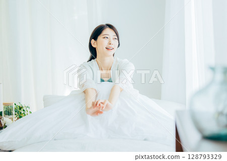 A woman relaxing in the bedroom 128793329