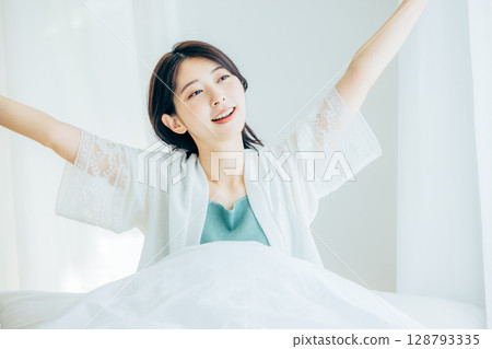 A woman relaxing in the bedroom 128793335