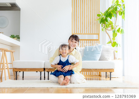Parents and children relaxing in the living room Parents and children relaxing in the living room 128793369