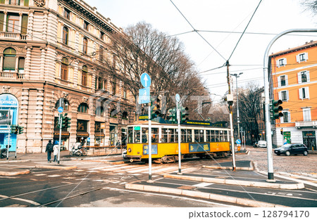 Winter in Milan: A street corner with a tram running Winter in Milan: A street corner with a tram running 128794170