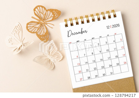 December 2026 desk calendar for the organizer to plan and reminder and butterfly paper on yellow background. 128794217