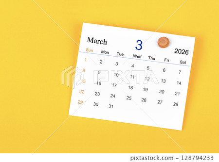 March 2026 card calendar and wooden push pin on yellow color wall. 128794233