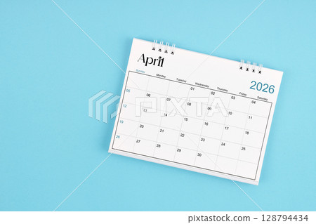 April 2026 Monthly desk calendar for 2026 year on blue color background. April 2026 Monthly desk calendar for 2026 year on blue color background. 128794434