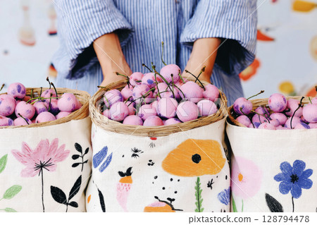 A striking modern house stands amidst a wild garden adorned with colorful foliage. The property features a spacious patio, perfect for enjoying nature's tranquility in autumn, banner 128794478