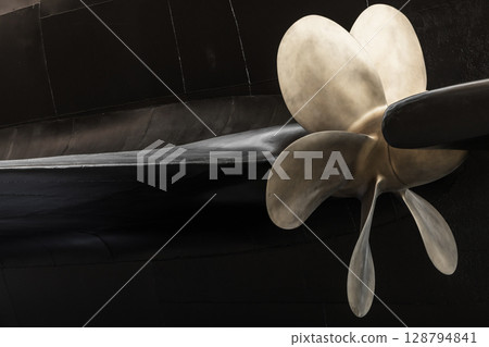 Ship Propeller Close-Up with Black Submarine Boat Hull Background Ship Propeller Close-Up with Black Submarine Boat Hull Background 128794841