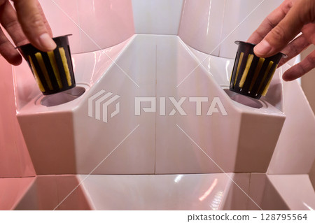 A Vertical Hydroponic Gardening System is actively in use for efficient plant cultivation A Vertical Hydroponic Gardening System is actively in use for efficient plant cultivation 128795564