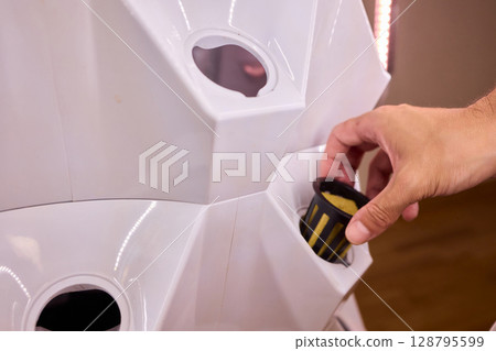 A Vertical Hydroponic Gardening System is actively in use for efficient plant cultivation 128795599