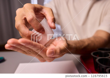 Hands Skillfully Managing Hydroponic Growing Medium with Exact Precise Careful Techniques Hands Skillfully Managing Hydroponic Growing Medium with Exact Precise Careful Techniques 128795615