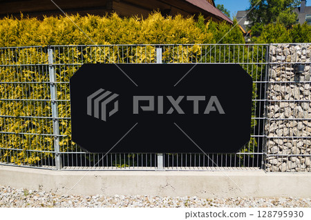 Blank Signboard on Metal Fence in Residential Area Blank Signboard on Metal Fence in Residential Area 128795930